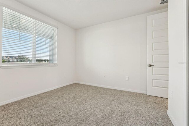 unfurnished room featuring carpet