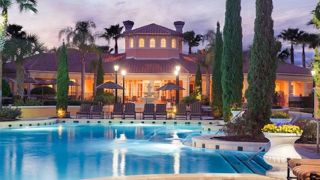 view of pool at dusk