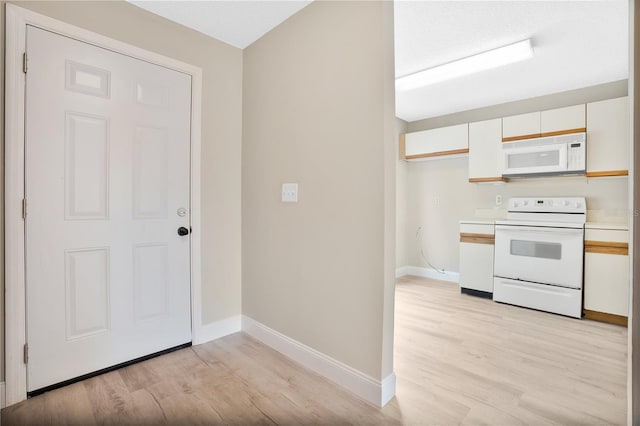 kitchen featuring light hardwood / wood-style floors, white cabinets, and white appliances