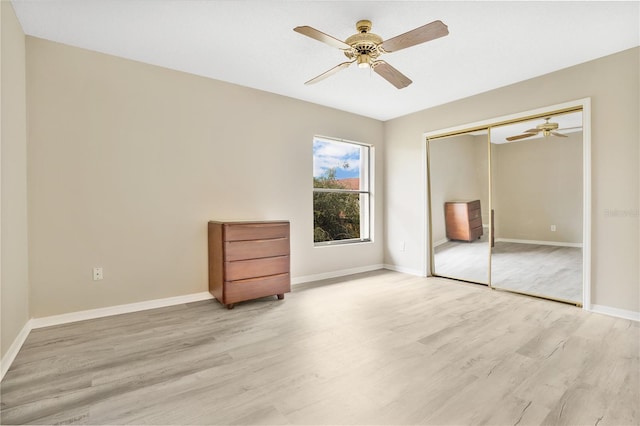 unfurnished bedroom with ceiling fan, a closet, and light hardwood / wood-style flooring