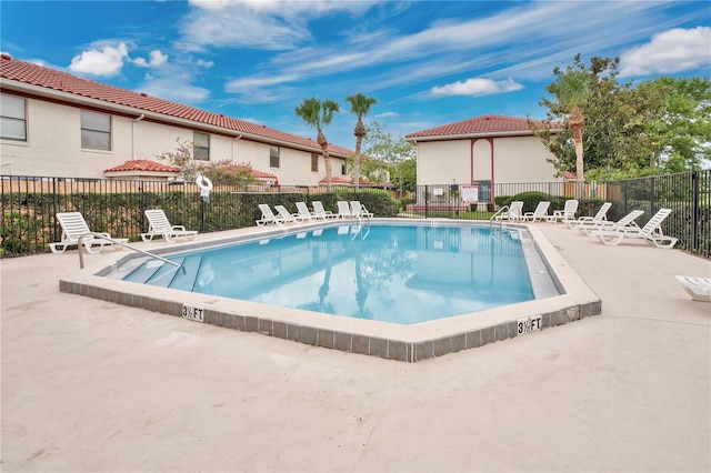 view of swimming pool with a patio