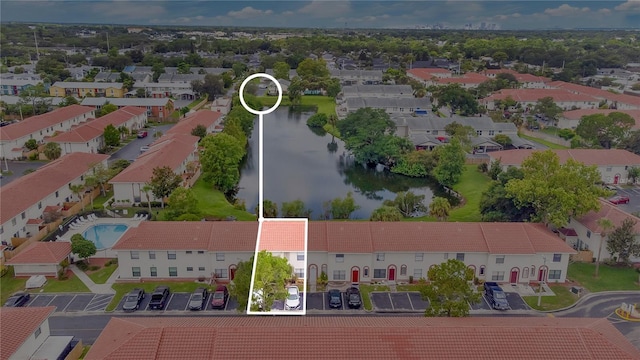 birds eye view of property with a water view