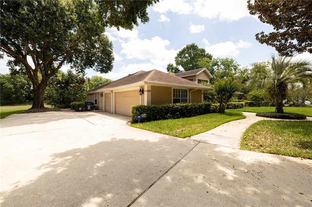 view of home's exterior with a garage and a yard