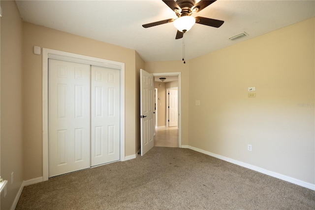 unfurnished bedroom with carpet floors, a closet, and ceiling fan