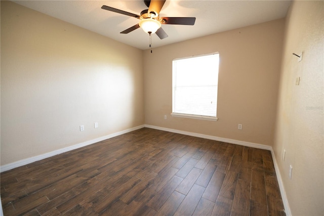 spare room featuring ceiling fan and dark hardwood / wood-style flooring