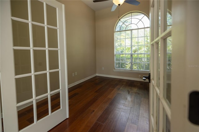 spare room featuring dark hardwood / wood-style floors, ceiling fan, and french doors