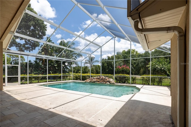 view of pool with a lanai and a patio