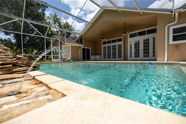 view of pool with a patio, french doors, ceiling fan, and glass enclosure