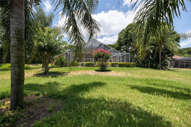 view of yard with glass enclosure