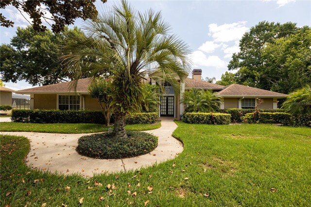 ranch-style house featuring a front yard