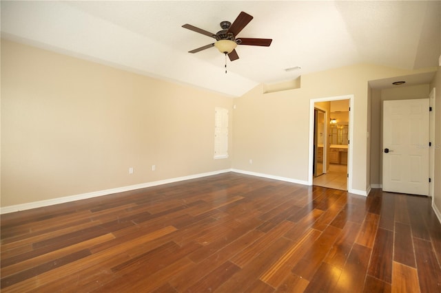 spare room with vaulted ceiling, dark wood-type flooring, and ceiling fan