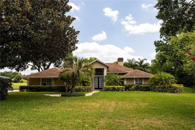 ranch-style house featuring a front lawn