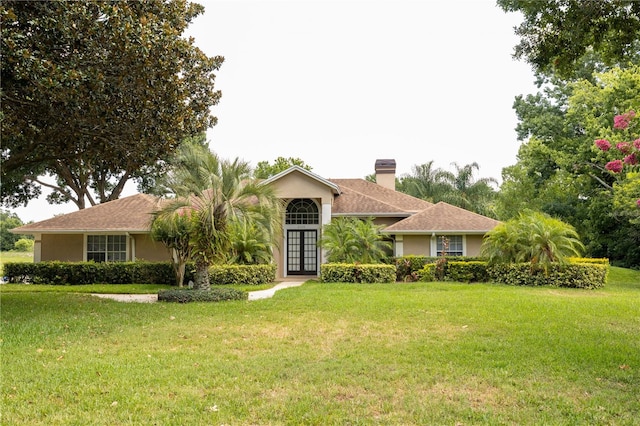 single story home featuring french doors and a front lawn