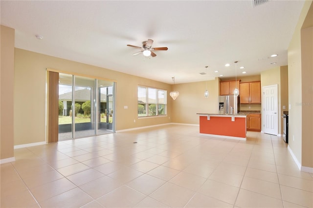 unfurnished living room featuring ceiling fan and light tile floors