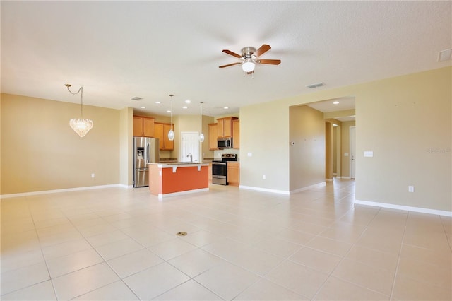 unfurnished living room featuring ceiling fan and light tile patterned floors