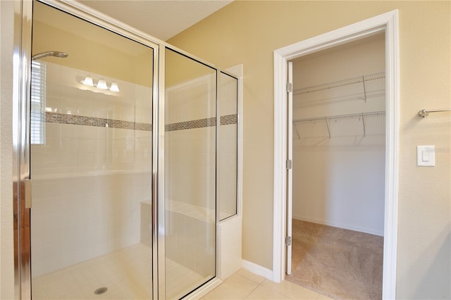 bathroom with tile patterned flooring and an enclosed shower