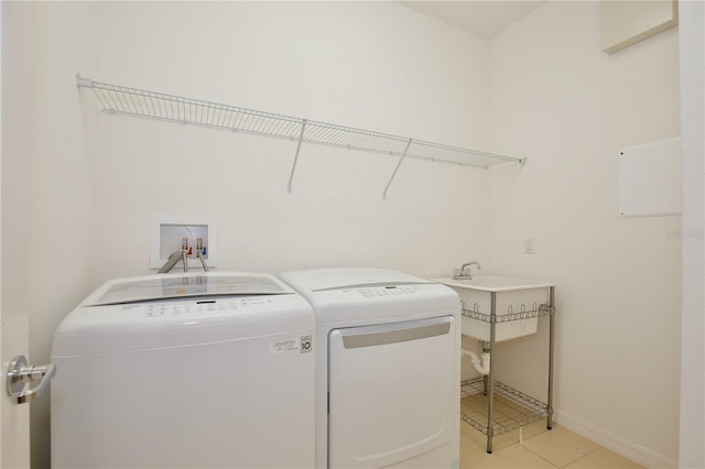 washroom featuring light tile patterned flooring and separate washer and dryer