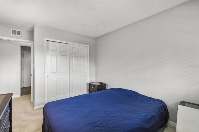 carpeted bedroom featuring a closet