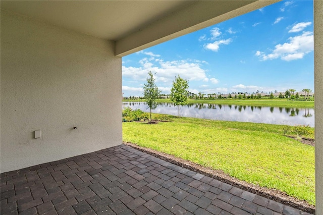 view of patio featuring a water view