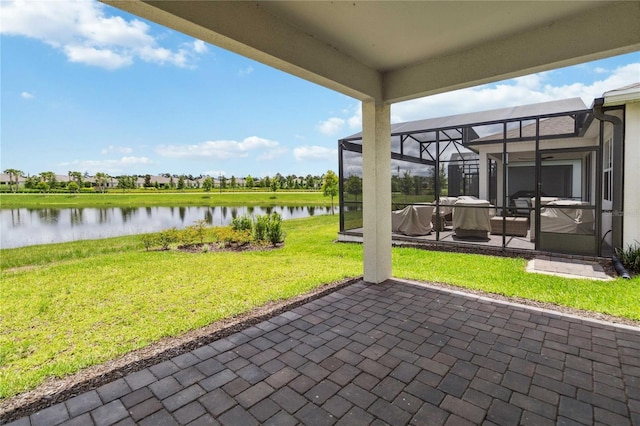 view of patio / terrace with a lanai and a water view