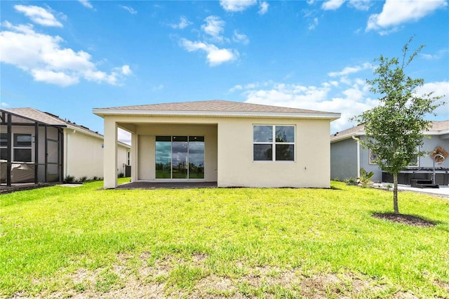 rear view of house with a lawn