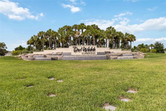 community sign featuring a lawn