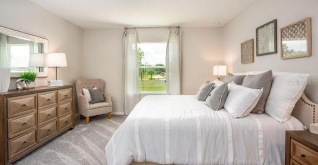 bedroom featuring light carpet