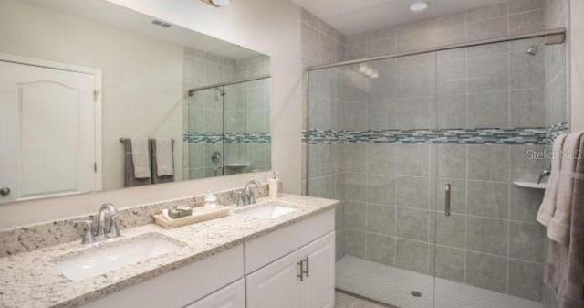 bathroom with walk in shower and vanity