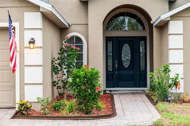 entrance to property with stucco siding