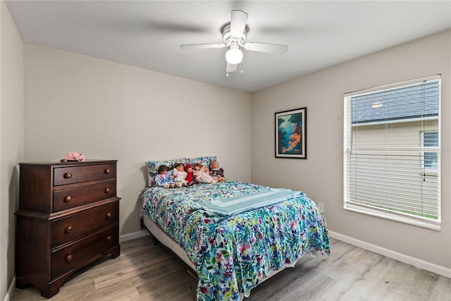 bedroom with light wood-type flooring and ceiling fan