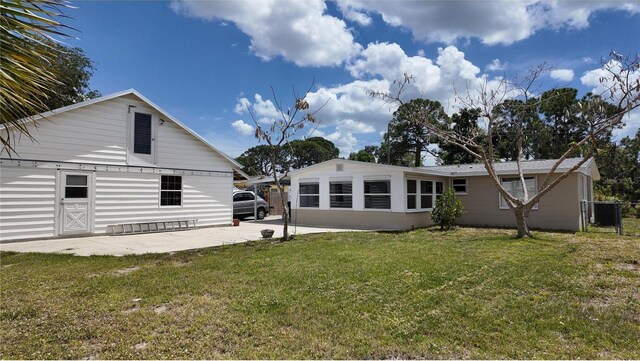 back of property featuring a patio and a yard