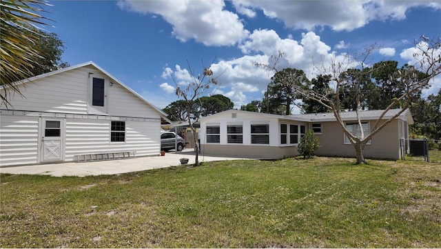 back of house featuring a yard and fence