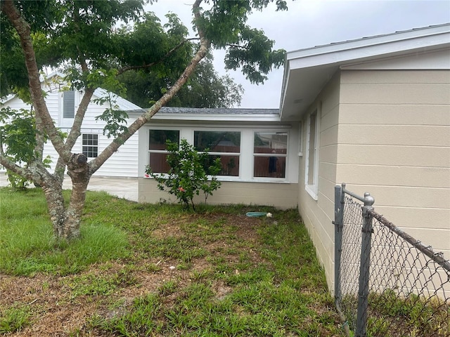 view of home's exterior featuring a yard and fence