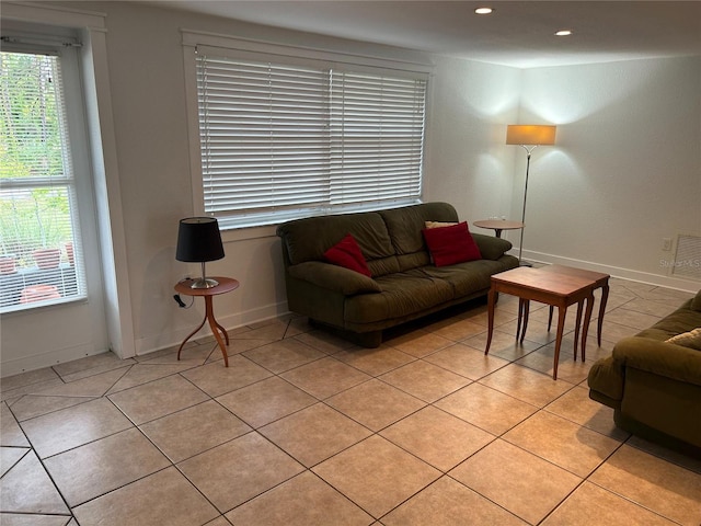 living area featuring light tile patterned floors, visible vents, baseboards, and recessed lighting