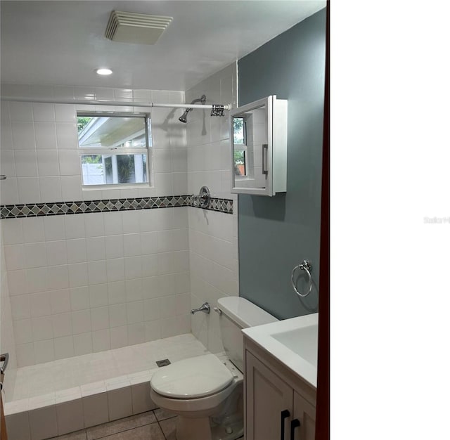 full bathroom with visible vents, toilet, a stall shower, vanity, and tile patterned flooring