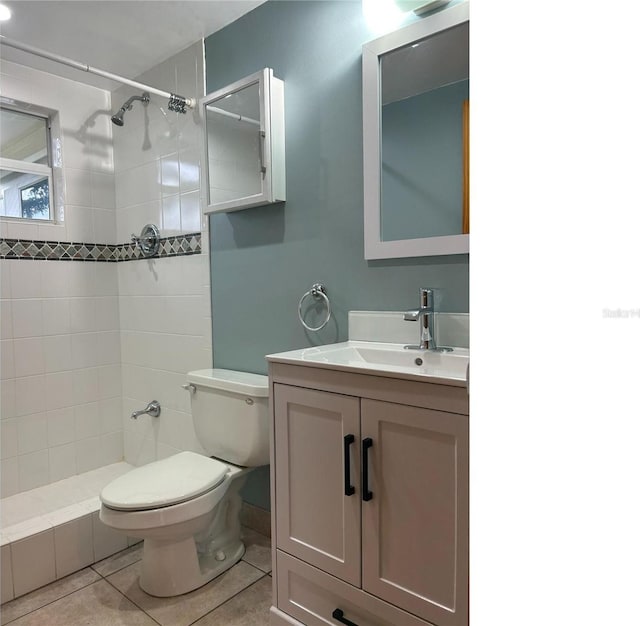 full bath featuring vanity, tile patterned flooring, toilet, and a shower stall