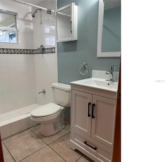 full bath featuring toilet, tile patterned floors, a shower stall, and vanity