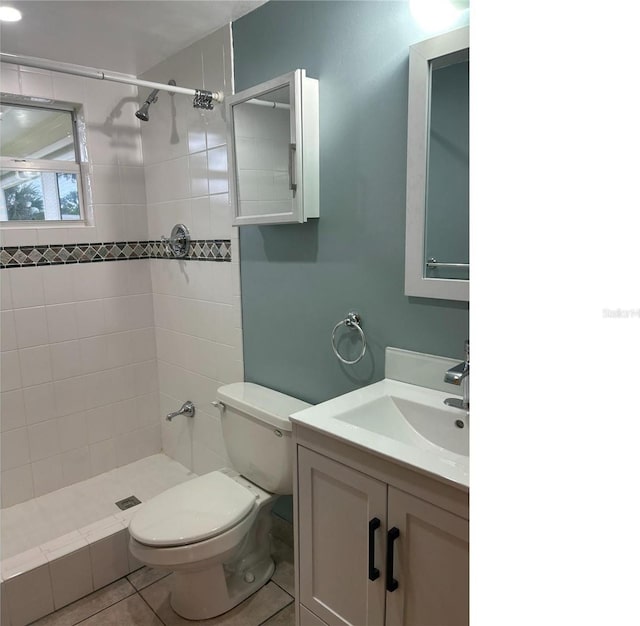 bathroom featuring a stall shower, vanity, toilet, and tile patterned floors