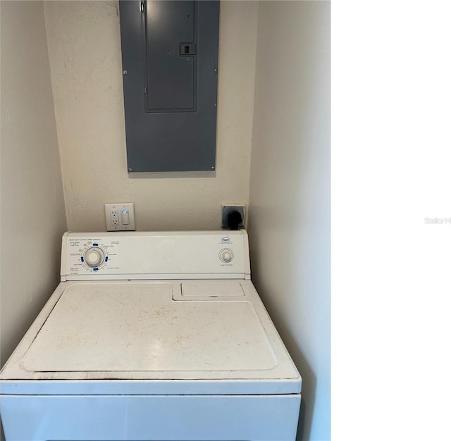 laundry room featuring laundry area, electric panel, and washer / clothes dryer