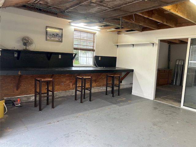 bar featuring unfinished concrete floors