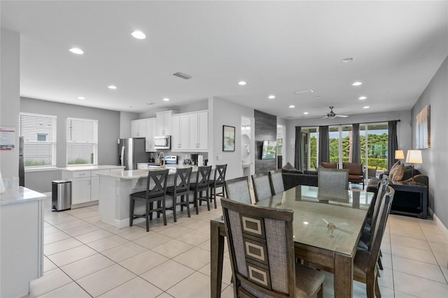 tiled dining room with ceiling fan