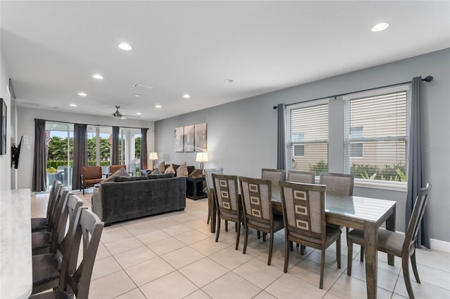 dining area with ceiling fan and light tile patterned floors