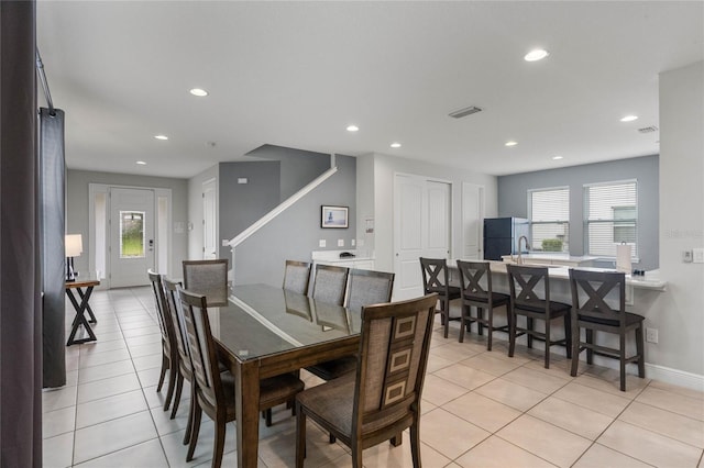 dining room featuring light tile patterned floors, a wealth of natural light, and sink