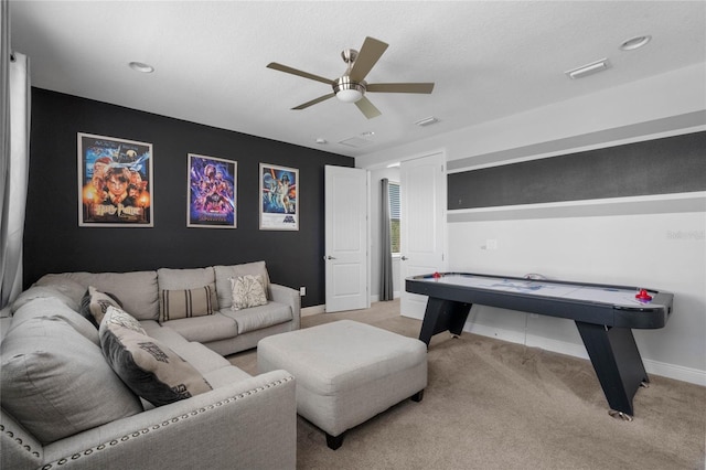 rec room featuring ceiling fan, light colored carpet, and a textured ceiling