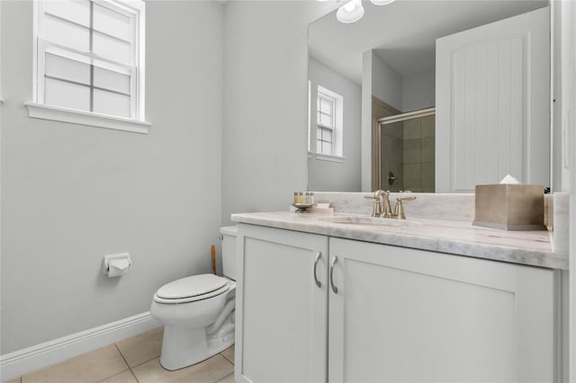 bathroom featuring toilet, vanity, tile patterned floors, and an enclosed shower