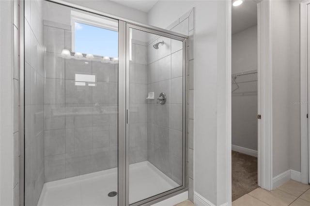 bathroom with tile patterned flooring and a shower with shower door