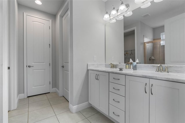 bathroom featuring vanity, tile patterned floors, and a shower with shower door