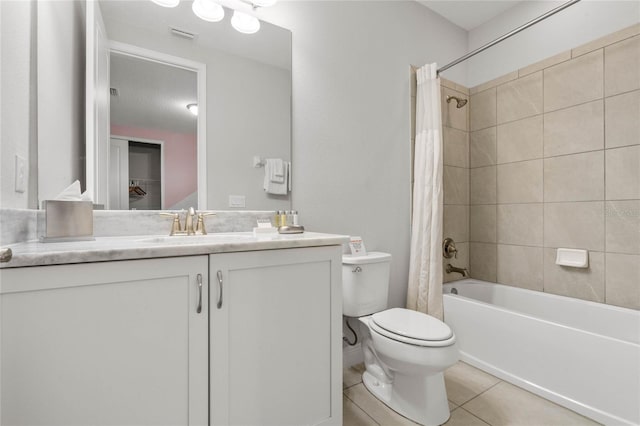 full bathroom featuring toilet, shower / tub combo with curtain, vanity, and tile patterned flooring