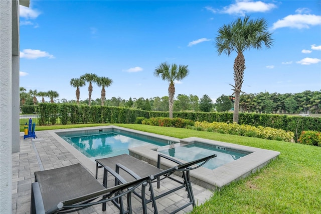 view of swimming pool with a lawn, a patio area, and an in ground hot tub