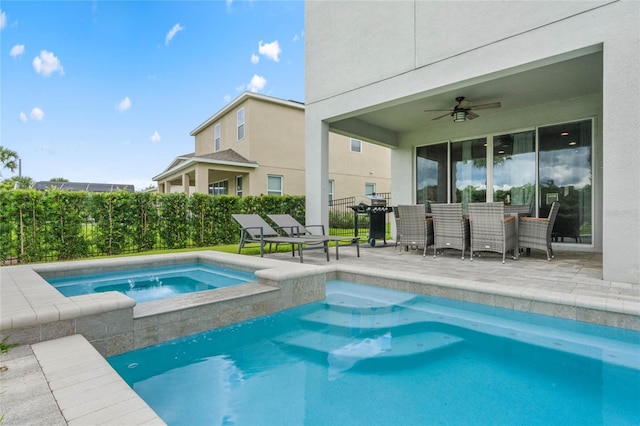 view of pool with an in ground hot tub, ceiling fan, and a patio area